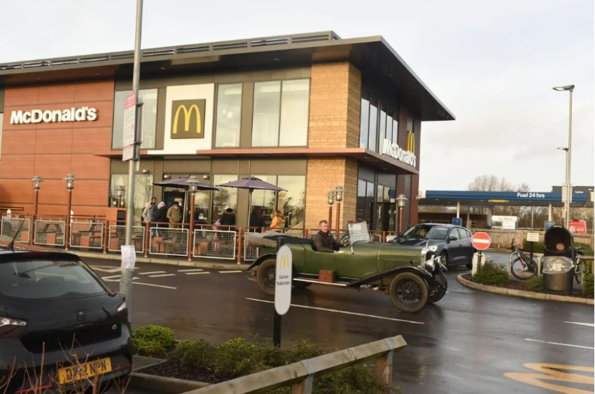 ​Марк і його Alvis 1931 року проїжджають повз McDonald’s. (Courtesy of Caters News)