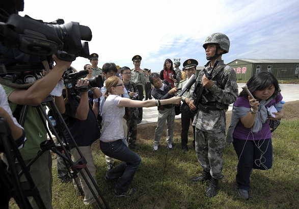 Пекін, 10 вересня 2009 року. Журналісти беруть інтерв'ю у китайського солдата в тренувальному таборі, де відбувається підготовка до параду напередодні національному свята. Фото: LIU JIN/AFP/Getty Images