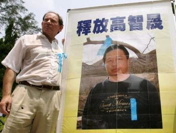Эдвард МакМамиллан-Скотт, вице-президент Европейского парламента, рядом с фото заключенного китайского правозащитника Гао Чжишена. Фото: Mike Clarke /AFP /Getty Image