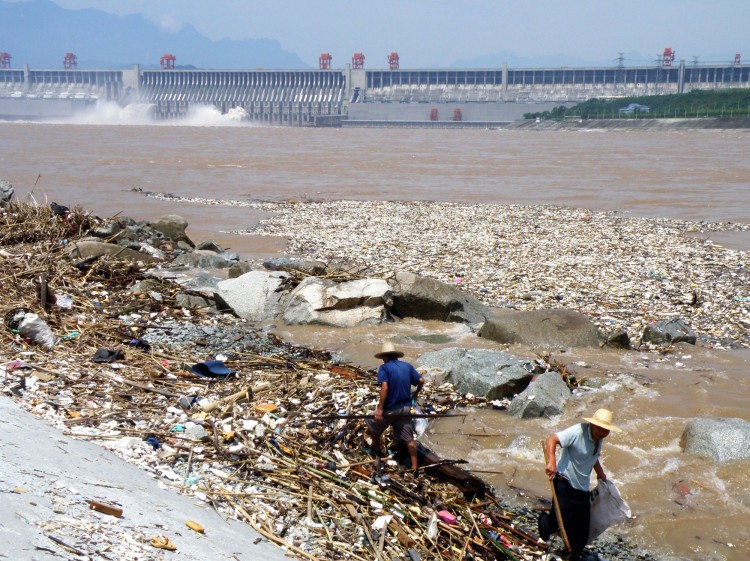 Робітники збирають сміття на узбережжі річки Янцзи недалеко від греблі «Трьох ущелин» в місті Ічан, 1 серпня 2010 р. Фото: STR/AFP/Getty Images