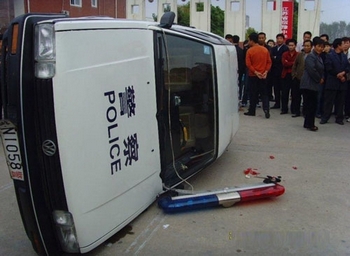 Возмущённые произволом властей люди, перевернули и разбили несколько полицейских машин. Фото с epochtimes.com