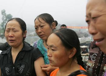 Скорбящие родители, дети которых погибли под обломками рухнувших зданий школ во время землетрясения в провинции Сычуань. Фото: China Photos/Getty Images