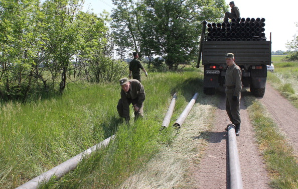 Російські солдати розвантажують залізні труби з вантажівок для прокладання трубопроводу у східному Криму. Район села Криничне, Крим, 13 травня 2014 року. Фото: YURIY LASHOV/AFP/Getty Images