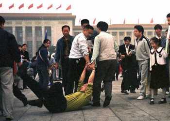 Полицейские агенты арестовывают последователя Фалуньгун, приехавшего в Пекин, чтобы обратиться к правительству. Фото с epochtimes.com
