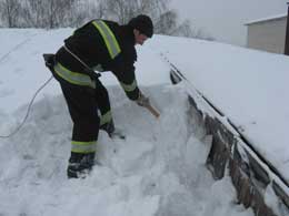 Сотрудник МЧС спасает от разрушения крышу ВПУ. 2010 год. Фото: mns.gov.ua