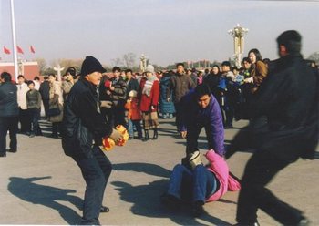 Китайские полицейские арестовывают последовательницу Фалуньгун, распространяющую материалы о репрессиях своих единомышленников. Фото с epochtimes.com