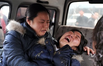 Жены погибших китайских шахтёров. Во время аварии на шахте в провинции Шаньси 22 февраля 2009 года погибло 74 горняка. Фото: GETTY IMAGES