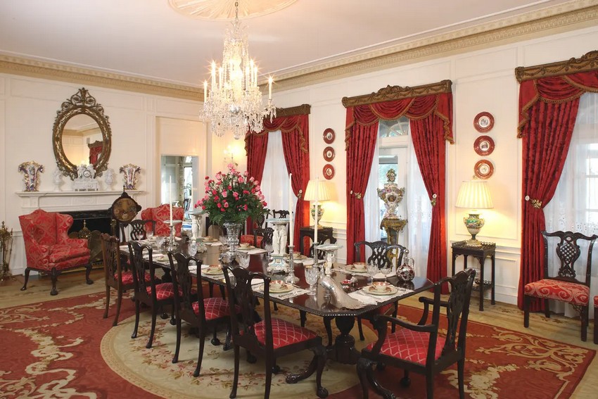 Столовая – самая большая комната в Беллинграте, ее длина составляет 9 метров. Стена из французской двери, ведущей в закрытую солнечную комнату и западный внутренний двор, увенчана изысканными резными и позолоченными деревянными карнизами. Дверь драпирована красным шелковым дамаском, украшенным золотой бахромой. Роскошь дополняет изысканная чехословацкая люстра и обеденный гарнитур в стиле Чиппендейл из красного дерева на 10 мест. Центральным элементом украшена серебряная ваза. (Bellingrath Gardens & Home)