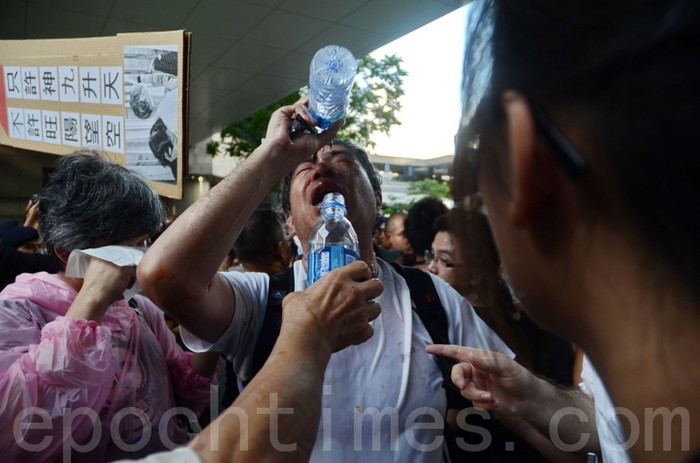 Демонстранти, які постраждали від перцевою води, якою поліцейські бризкали їм в обличчя. Фото: Велика Епоха 